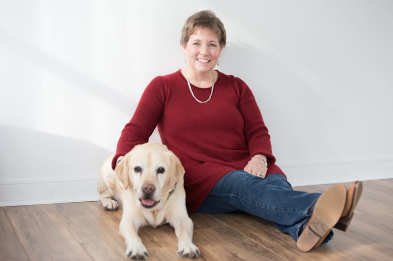 dog gurus robin sitting with her happy dog